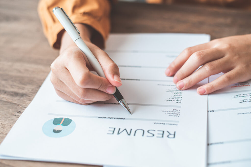 A person filling out a resume